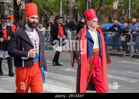 Sardinian men dressed in folk traditional costumes, with unique elements representing the area they come from, join the Saint Efisio Feast festival Stock Photo