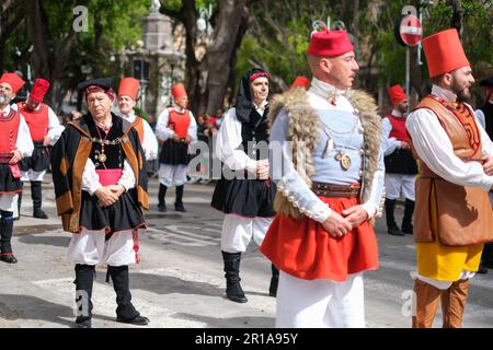 Sardinian men dressed in folk traditional costumes, with unique elements representing the area they come from, join the Saint Efisio Feast festival Stock Photo