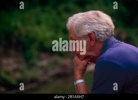 An older man sitting and thinking deeply in the evening light, Missouri, USA Stock Photo