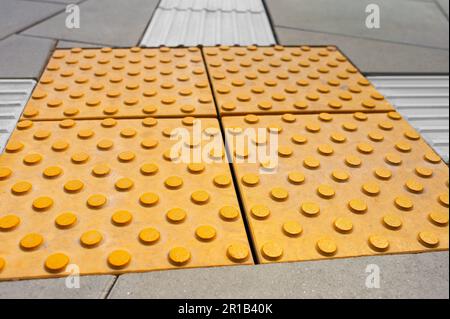 Tiles with tactile ground surface indicators, closeup view Stock Photo