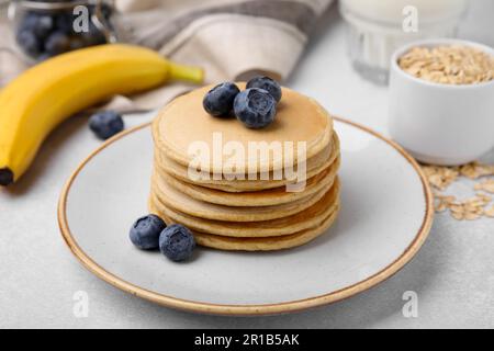 Tasty Oatmeal Pancakes On Grey Table, Closeup Stock Photo - Alamy