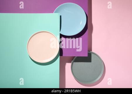 Abstract composition made of plates on color background, flat lay Stock Photo