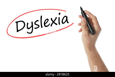 Man writing word Dyslexia on white background, closeup Stock Photo