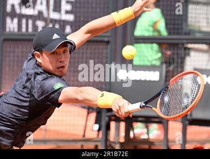 Rome, Italy. 12th May, 2023. Wu Yibing of China hits a return during the round of 64 match between Wu Yibing of China and Francisco Cerundolo of Argentina at the Men's ATP Rome Open tennis tournament in Rome, Italy, May 12, 2023. Credit: Alberto Lingria/Xinhua/Alamy Live News Stock Photo