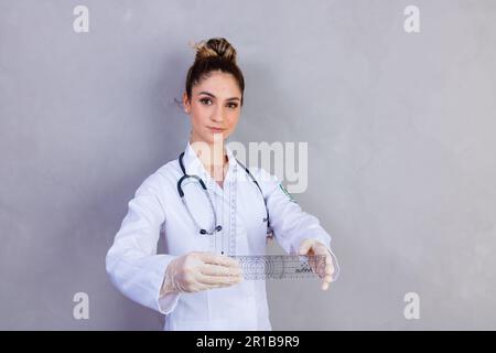 physiotherapist with a goniometry in grey background Stock Photo