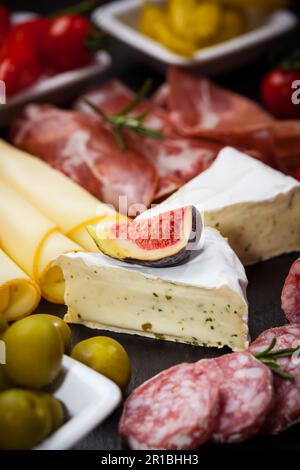 Antipasti and catering platter with different meat and cheese products Stock Photo