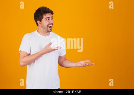 handsome man pointing to the side with space for text Stock Photo