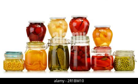 Jars with pickled vegetables and fruity compotes isolated on white background. Preserved food Stock Photo