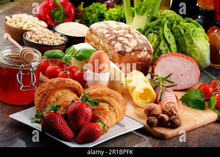 Composition with variety of organic food products on kitchen table Stock Photo