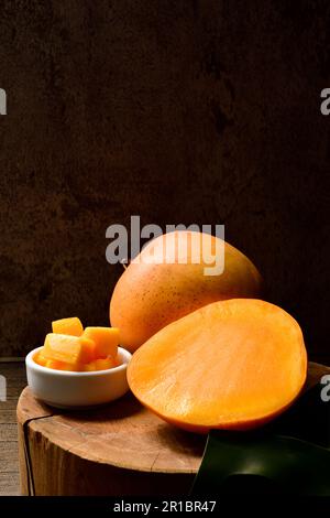 mango and mango slice with cubes on Black background.Thai Mangoes.Thai Fruit.Copy text.Copy Space. Stock Photo