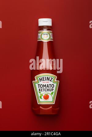 LONDON,UK - APRIL 21, 2023 : Bottle of Original Heinz tomato ketchup on red background.Top view. Stock Photo