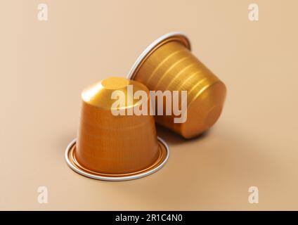 Yellow capsules with fresh coffee drink for coffee machine on beige. Stock Photo