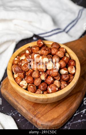 Hazelnut. Peeled hazelnuts in wooden bowl. Superfood. Vegetarian food concept. Healthy snacks. Close up Stock Photo