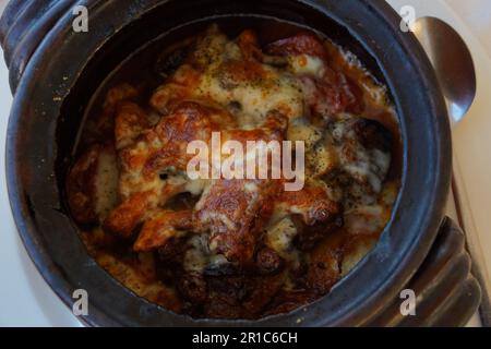 Braised beef with oven baked potatoes under cheese crust in clay bowl Stock Photo