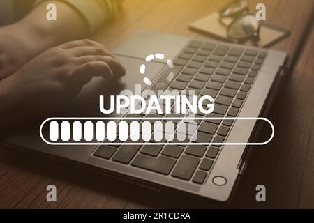 Woman use laptop to update software. System engineer and programming. Software apps developer. Download applications. Stock Photo