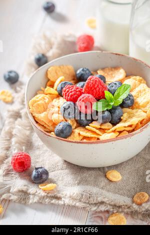 Fresh and delicious cornflakes with berries and milk for breakfast. Cornflakes with berries as healthy breakfast. Stock Photo