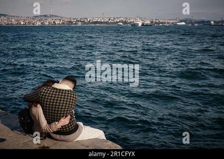 A couple in love celebrates their engagement on the seashore in Istanbul  Stock Photo