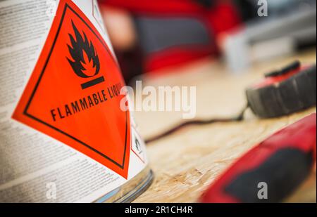 Flammable Liquid at Work. Metal Can with Dangerous Liquid Inside. Stock Photo