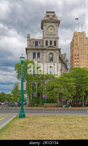 Gridley Building, originally Onondaga County Savings Bank Building, is a grey stone landmark with clock tower facing Clinton Square. Stock Photo