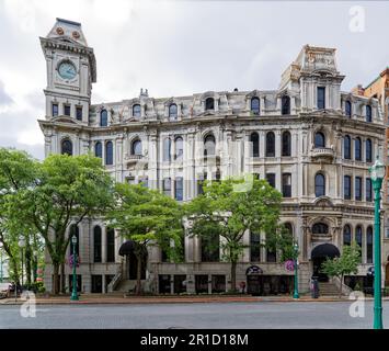 Gridley Building, originally Onondaga County Savings Bank Building, is a grey stone landmark with clock tower facing Clinton Square. Stock Photo