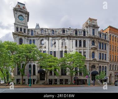 Gridley Building, originally Onondaga County Savings Bank Building, is a grey stone landmark with clock tower facing Clinton Square. Stock Photo