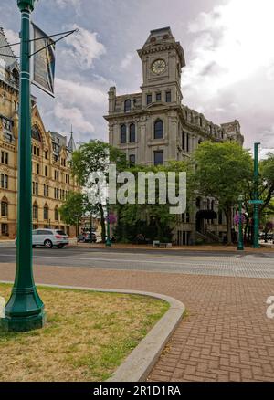 Gridley Building, originally Onondaga County Savings Bank Building, is a grey stone landmark with clock tower facing Clinton Square. Stock Photo