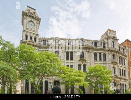 Gridley Building, originally Onondaga County Savings Bank Building, is a grey stone landmark with clock tower facing Clinton Square. Stock Photo