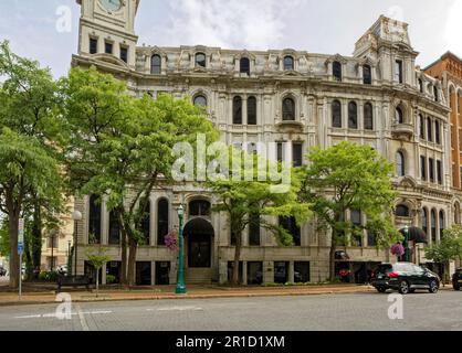 Gridley Building, originally Onondaga County Savings Bank Building, is a grey stone landmark with clock tower facing Clinton Square. Stock Photo