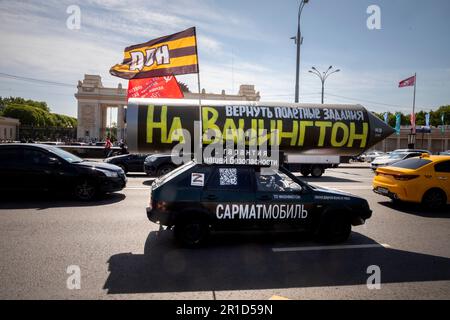 Moscow, Russia. 13th May, 2023. A vehicle with a mock Russian missile with the inscription reading 'Let's program it again to target Washington' drives on a central street in Moscow, Russia. Pro-Kremlin activist Ravil Garifullin, a resident of the city of Kazan, makes a four-month propaganda rally in his car across Russia Stock Photo