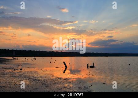 The photo was taken in Ukraine, near the city of Odessa. The picture shows an incredible beauty of sunset over a salt estuary. Stock Photo