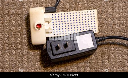 A Lithium Battery and 120 Volt Charger Stock Photo