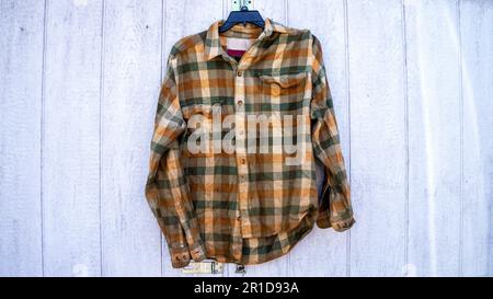 Old Flannel Shirt in Front of a White Background Stock Photo