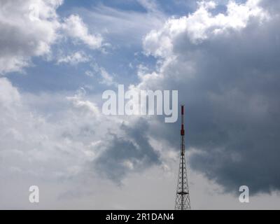telecomunication tower in cloudy sky Stock Photo