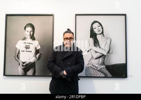 London UK. 13 May 2023. Michel Haddi (pictured)  stands with portraits of Cameron Diaz, Vogue Hommes Magazine Venice Beach, California1993, Kate Moss for British GQ, New York1991 Courtesy of 29 ARTS IN PROGRESS gallery. The eight edition of Photo London at Somerset House London showcasing 126 leading international galleries and publishers who  show and sell work by photographers with  curated exhibitions and talks. Credit: amer ghazzal/Alamy Live News Stock Photo