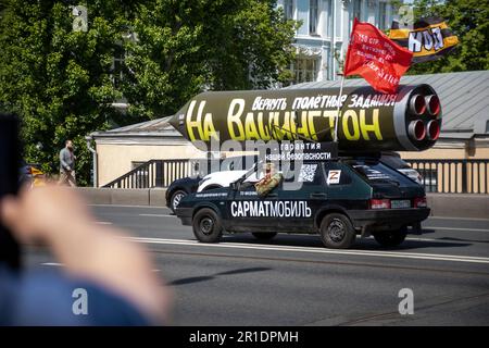 Moscow, Russia. 13th May, 2023. A vehicle with a mock Russian missile with the inscription reading 'Let's program it again to target Washington' drives on a central street in Moscow, Russia. Pro-Kremlin activist Ravil Garifullin, a resident of the city of Kazan, makes a four-month propaganda rally in his car across Russia Stock Photo