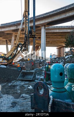 Oxygen tanks are in the foreground with a drilling rig for digging ...