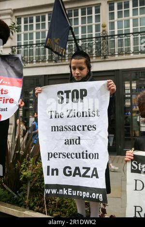 London, UK. 13th May, 2023. An Orthodox Jew holds a placard in support of ‘Free Palestine - End Apartheid' as demonstrators march in central London to mark Nakba Day. Credit: SOPA Images Limited/Alamy Live News Stock Photo