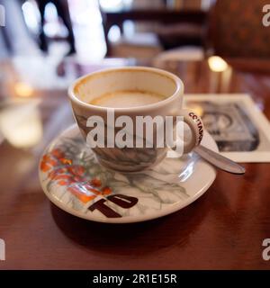 Cup of cappuccino half drunk on a table in a cafe Stock Photo