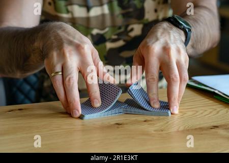 man shuffle cards while playing with friends . Stock Photo