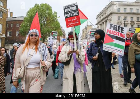 London, UK. 13th May, 2023. Protesters hold placards during a march and rally in central London to commemorate the 75th anniversary of the Nakba day, also known as the Palestinian Catastrophe. Nakba was the process of, what they consider to be, 'ethnic cleansing, colonisation and dispossession which saw over 750,000 Palestinians driven into exile. Credit: SOPA Images Limited/Alamy Live News Stock Photo