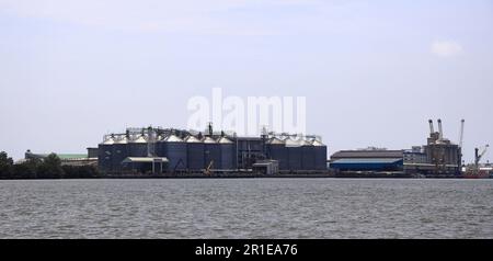 Panorama of Big grain silos at river bank in south east asia. Stock Photo