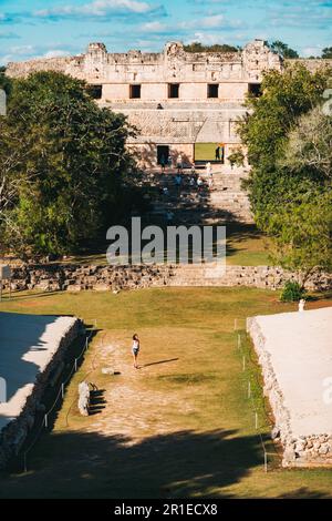 tourists walk through El Palomar (The House of the Doves) ruins at Uxmal, an ancient Mayan city on the Yucatan Peninsula, Mexico Stock Photo