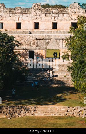 tourists walk through El Palomar (The House of the Doves) ruins at Uxmal, an ancient Mayan city on the Yucatan Peninsula, Mexico Stock Photo