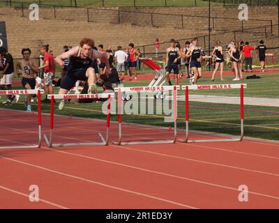 High School Track & Field competition in New Jersey, USA including boys and girls sprints and boys high hurdles. Stock Photo
