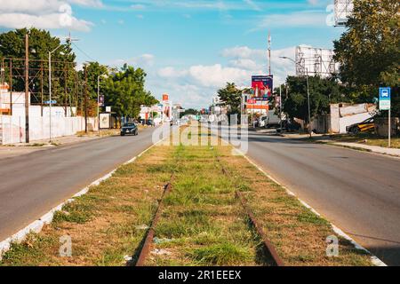 old unused train tracks run down the middle of a road in Merida, Mexico Stock Photo