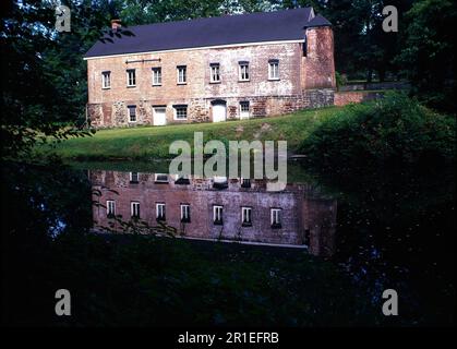 Old iron mill building on a lake Stock Photo