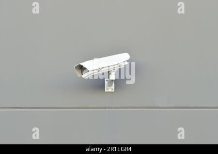 security camera working on the wall of a building Stock Photo