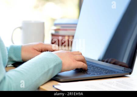 Cropped shot of an unrecognizable businesswoman working on his laptop while sitting in the home office Stock Photo