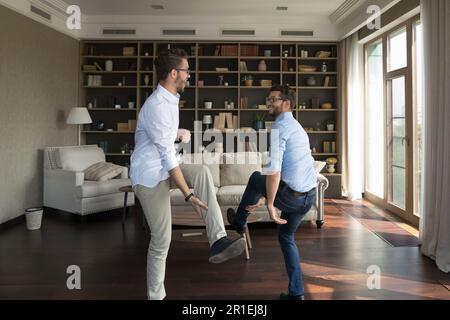 Two happy cheerful twin brothers having fun at home Stock Photo
