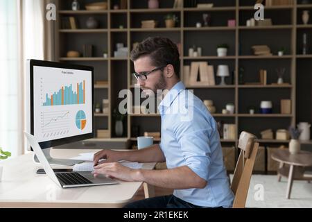 Focused young freelance business man analyzing financial data Stock Photo